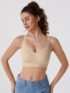 Close-up of seamless apricot nursing bra with breathable micro-pores and wide straps
