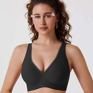 Seamless deep V-neck black bra with mesh trim and wide straps on female model