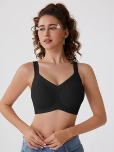 Close-up of seamless black V-neck sports bra with wide straps and high elastic fabric