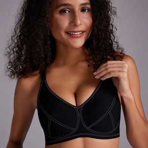 Detail view of black seamless wire-free bra with contrast white stitching on front