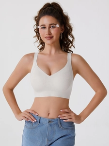Breathable cream seamless sports bra with wide straps and V-neckline support