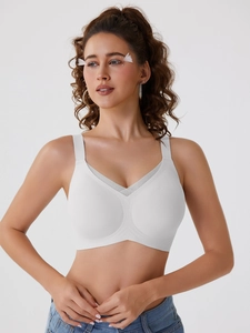 Detail of white seamless wireless bra with V-shaped mesh panel and wide shoulder straps