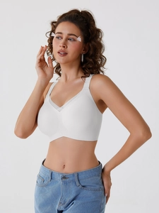 Close-up of white seamless bra with mesh trim and wide straps for comfortable support