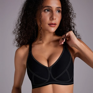 Seamless wire-free black sports bra with contrast white stitching and V-neck design