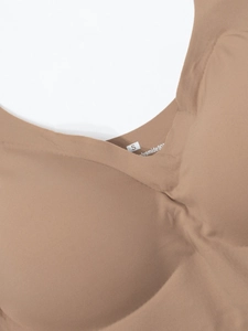 Detail view of seamless beige vest with Polyamide fabric texture and size S label