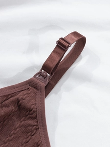 Macro shot of nursing bra featuring leaf pattern texture and convenient breastfeeding buckle