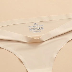 Close-up of seamless nude thong with printed care label and fabric composition