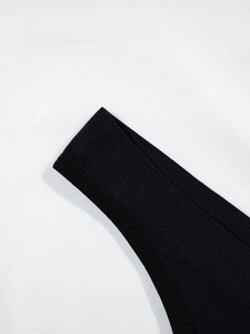 Detailed close-up of seamless black thong featuring premium stitching and elastic fabric