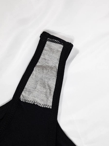 Detail of gray inner crotch lining with zigzag stitching on black seamless thong