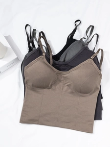 Detail view of seamless camisole crop tops with ribbed hem and integrated cups
