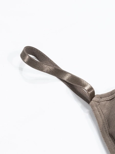 Detail view of seamless taupe bra straps with satin finish and fine stitching work