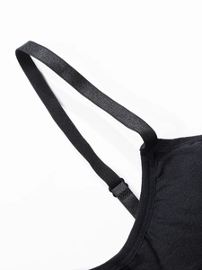 Detail of adjustable elastic shoulder strap on a seamless black camisole top