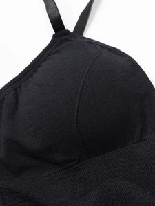 Close-up of black seamless sports bra featuring breathable knit fabric and fine stitching