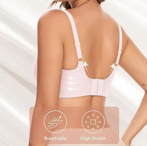 Detail view of pink seamless deep V bra with adjustable straps and breathable fabric