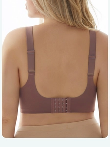 Detail of seamless bra back showing four-row hook-and-eye closure and wide straps