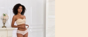 Seamless nude bandeau bra and panty set shown on model in a modern interior setting
