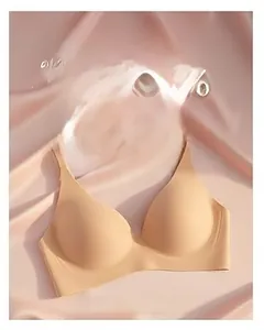 Close-up of nude seamless wire-free bra on elegant pink silk fabric with soft shadows