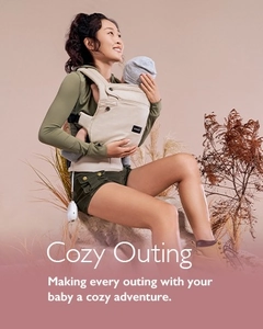 Breathable baby carrier with wide shoulder straps shown in an outdoor setting