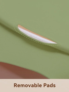 Detailed macro view showing the removable foam pads inside the green seamless bra