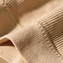 Macro detail of nude padded bralette showing breathable mesh and ribbed hem texture