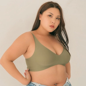 Detail view of olive green seamless V-neck bra showing soft fabric on curvy model