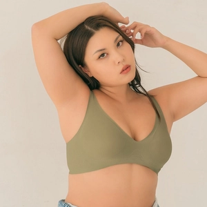 Seamless V-neck olive green bralette worn by model, showing soft support and sleek fit