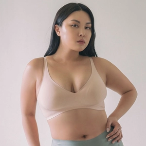 Close-up of seamless V-neck wireless bra in nude with thin straps and smooth fabric
