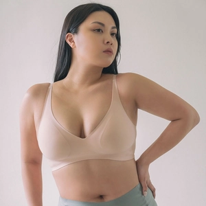 Detail view of seamless beige V-neck bralette with breathable soft support fabric