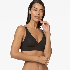 Front view of black seamless V-neck bralette on model with comfortable wireless design