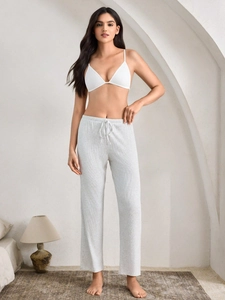 Close-up of light grey striped lounge pants with a comfortable drawstring waist design