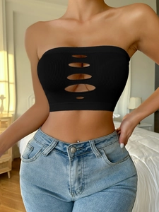 Close-up of black ribbed seamless tube top with five vertical oval cut-outs and soft texture