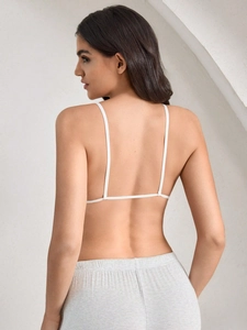 Back view of a white spaghetti strap bra top paired with ribbed lounge pants