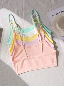 Flat lay of seamless cotton camisoles for teen girls in five vibrant pastel colors