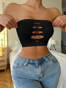 Detail of black ribbed tube top featuring five horizontal oval cut-outs on the front