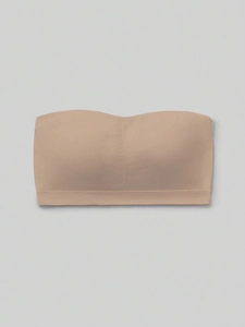 Detailed view of nude seamless bandeau bra for girls with elastic fabric texture