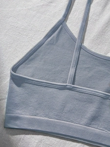 Close-up of seamless knitted girl's bralette with ribbed band and fine texture detail