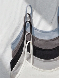 Close-up of ribbed knit camisoles in four colors with thin straps and seamless design
