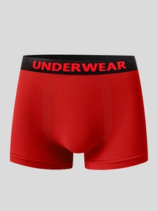 Detail view of red men's boxer briefs with elastic black waistband and U-convex design