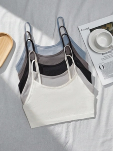 Detail showing five seamless cotton bralettes in various colors for teen girls