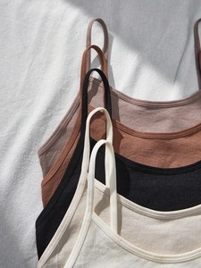 Close-up of seamless ribbed camisoles for teen girls in four earth-tone colors