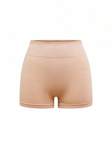 Detail of high-waisted seamless body shaper in beige with honeycomb texture for tummy control