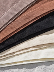 Detailed view of 5-pack seamless stretch fabric bras for girls in neutral earth tones