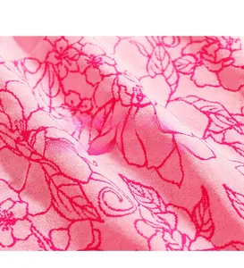 Close-up of pink seamless jacquard fabric with floral pattern and soft knit texture