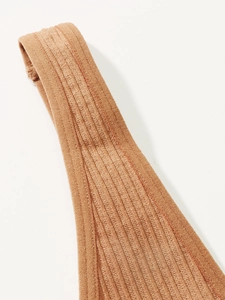 Detail view of seamless ribbed fabric shoulder strap in burnt orange color for women