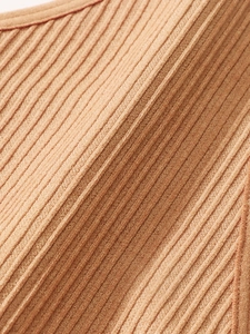 Macro shot of seamless ribbed knit fabric in caramel showing breathable soft texture