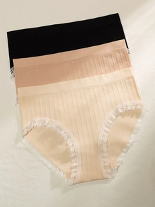 Close-up of seamless nylon lace panties in black, pink and beige with ribbed texture