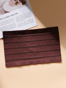 Detail of seamless ribbed tube top in dark coffee color with refined knitted texture