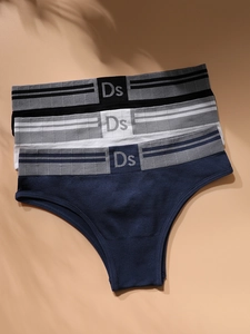 Three pack of seamless low waist panties in black, white and blue with striped waistbands
