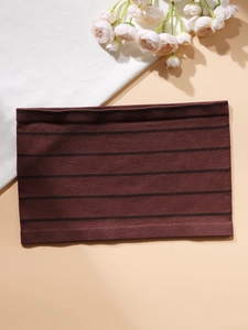 Detailed macro view of the seamless brown striped knitted tube top with ribbed edges
