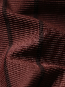 Detailed macro view of dark reddish-brown ribbed knit fabric with fine black stripes